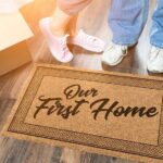 Moving boxes and a welcome mat in young couple's first home